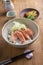 Traditional Japanese hokkaidon thinly sliced salmon donburi in a bowl