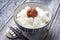 Traditional Japanese koshihikari rice with umeboshi offered  in a bowl on a wooden board