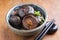 Traditional Japanese pickled Shiitake in a design bowl on a wooden board