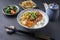 Traditional Japanese salmon sashimi with rice and vegetable on a design bowl