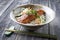 Traditional Japanese salmon teriyaki with rice and vegetable in a design bowl with chopstick