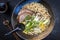 Traditional Japanese shoyu ramen soup with chashu in a design bowl with chopsticks