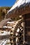 Traditional Japanese water mill with a thatched roof house in Iyashino-Sato Nenba traditional village covered by snow in the Saiko