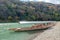 Traditional japanese wooden boat anchored on green river in autumn season at Arashiyama