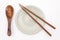 Traditional Japanese wooden chopstick on white ceramic plate and