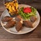 Traditional kebbe and pita bread on big round plate in lebanese restaurant