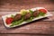 Traditional kebbe and pita bread on big round plate in lebanese restaurant