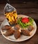 Traditional kebbe and pita bread on big round plate in lebanese restaurant