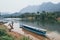 Traditional Laotian wooden slow boat on Nam Ou river near Nong Khiaw village, Laos