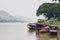Traditional Laotian wooden slow boats on Mekong river near Luang Prabang, Laos