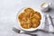 Traditional latkes fritters with sour cream on a light gray textured background