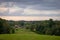 Traditional Latvian rural landscape with hay rolls and forest in the distance