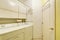 Traditional laundry room with tile floor, and washer dryer combo.