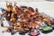 Traditional local african souvenir market on the street with rows of carved hand painted wooden bowls, giraffes, elephants with co