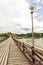 Traditional long wooden Mon Bridge in Songkhla Buri, Thailand.