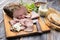 Traditional lunch meat with sliced cold cuts roast beef, remoulade and farmhouse bread on a cutting board