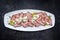 Traditional lunch meat with sliced cold cuts roast beef and remoulade on a white design plate