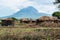 Traditional Maasai Village with Clay Round Huts in Engare Sero area near Lake Natron and Ol Doinyo Lengai volcano in