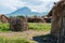 Traditional Maasai Village with Clay Round Huts in Engare Sero area near Lake Natron and Ol Doinyo Lengai volcano in