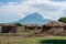 Traditional Maasai Village with Clay Round Huts in Engare Sero area near Lake Natron and Ol Doinyo Lengai volcano in