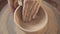 Traditional making of pottery from clay: potter makes cup, view above