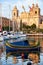 Traditional maltese boat Luzzu moored in the harbor in front of