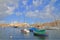 Traditional Maltese boats moored in the harbor of the island