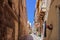 Traditional Maltese limestone buildings with coloured balconies in the vibrant alleys of the old city Birgu