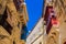 Traditional Maltese limestone buildings with coloured balconies in the vibrant alleys of the old city Birgu, Citta Vittoriosa