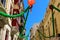 Traditional Maltese limestone buildings with hanging decorations around coloured balconies in the old city Birgu, Citta Vittoriosa