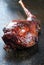 Traditional marinated barbecue aged leg of venison with bone on rustic background