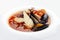 Traditional Marseille Bouillabaisse fish soup with prawns, mussels tomato,lobster, squid