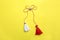 Traditional martisor on yellow background, top view. Beginning of spring celebration