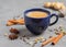 Traditional masala chai tea. Indian hot drink made from black tea with milk and various spices on gray background with copy space