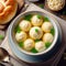 Traditional matzo ball soup in a bowl with freshly baked challah bread