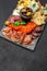 Traditional meat and cheese plate - parmesan, meat, sausage and olives