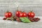 Traditional mediterranean kitchen - delicious dried tomatoes with fresh tomatoes, rosemary branch and basil leaf on wooden desk