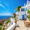 Traditional Mediterranean white house with terrace on hill with stunning view. Summer vacation background