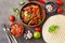 Traditional mexican cuisine , fajitas ,salsa sauce,tortilla on a dark rustic background. View from above, flat lay, copy space