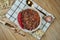 A traditional Mexican dish is chili con carne soup with stewed beef in a composition with spices on a wooden background. Tasty