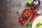 Traditional mexican homemade salsa sauce,spices and tortilla on a dark rustic background. Top view, flat lay, copy space