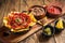 Traditional mexican refried beans with nachos, jalapeno and tomato sauce. Wooden background. Top view