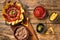 Traditional mexican refried beans with nachos, jalapeno and tomato sauce. Wooden background. Top view