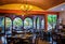Traditional mexican restaurant interior with chairs and tables, chandelier and brick ceiling