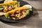 Traditional mexican taco with chicken and vegetables on wooden table. Latin american food