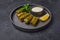 Traditional Middle Eastern dish dolma or sarma, with parsley, saucepan with sour cream and lemon
