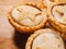 Traditional mince pie pastry on a wooden table. Popular Christmas season dessert. Close up