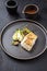 Traditional modern style Thai fried skrei cod fish filet with bok choi and mushrooms on a design plate