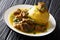 Traditional Mofongo with plantains, garlic and chicharron served with meat and broth close-up on a plate. horizontal