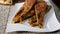 A traditional Moroccan Berber pizza is being cut into pieces.